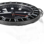 Seestern S462 titanium GMT brushed bezel and lug close-up on black, steel bracelet detail