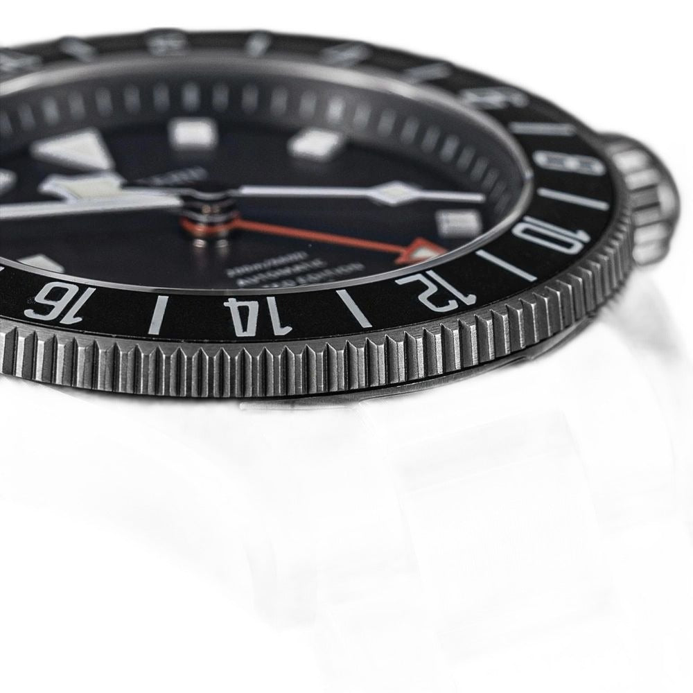 Seestern S462 titanium GMT brushed bezel and lug close-up on black, steel bracelet detail