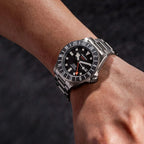 Seestern S462 titanium GMT black-dial diver worn on wrist with steel bracelet, close-up
