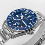 Seestern S462 titanium GMT, blue dial, dramatic angled close-up on white, steel bracelet