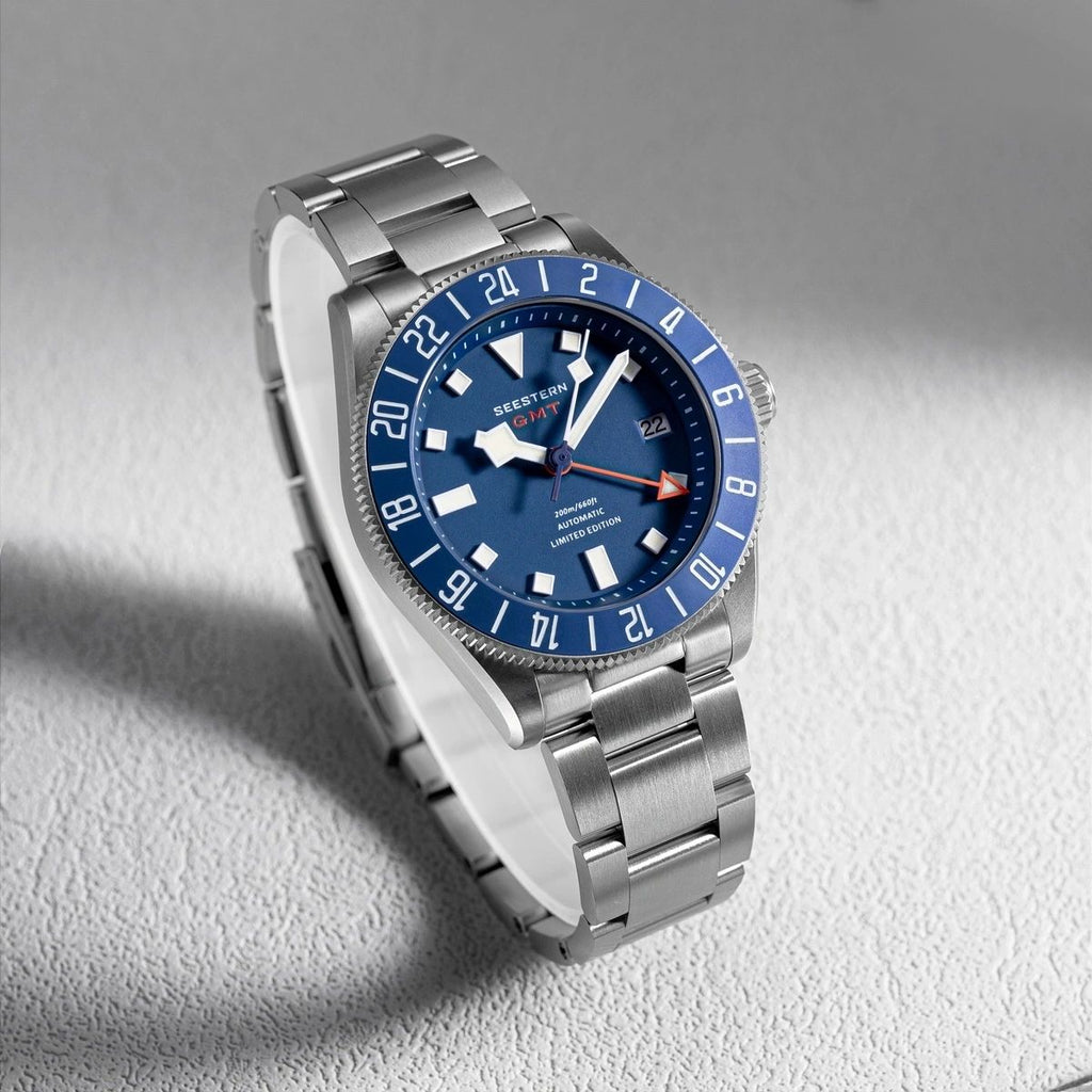 Seestern S462 titanium GMT, blue dial, angled studio product view on grey, steel bracelet