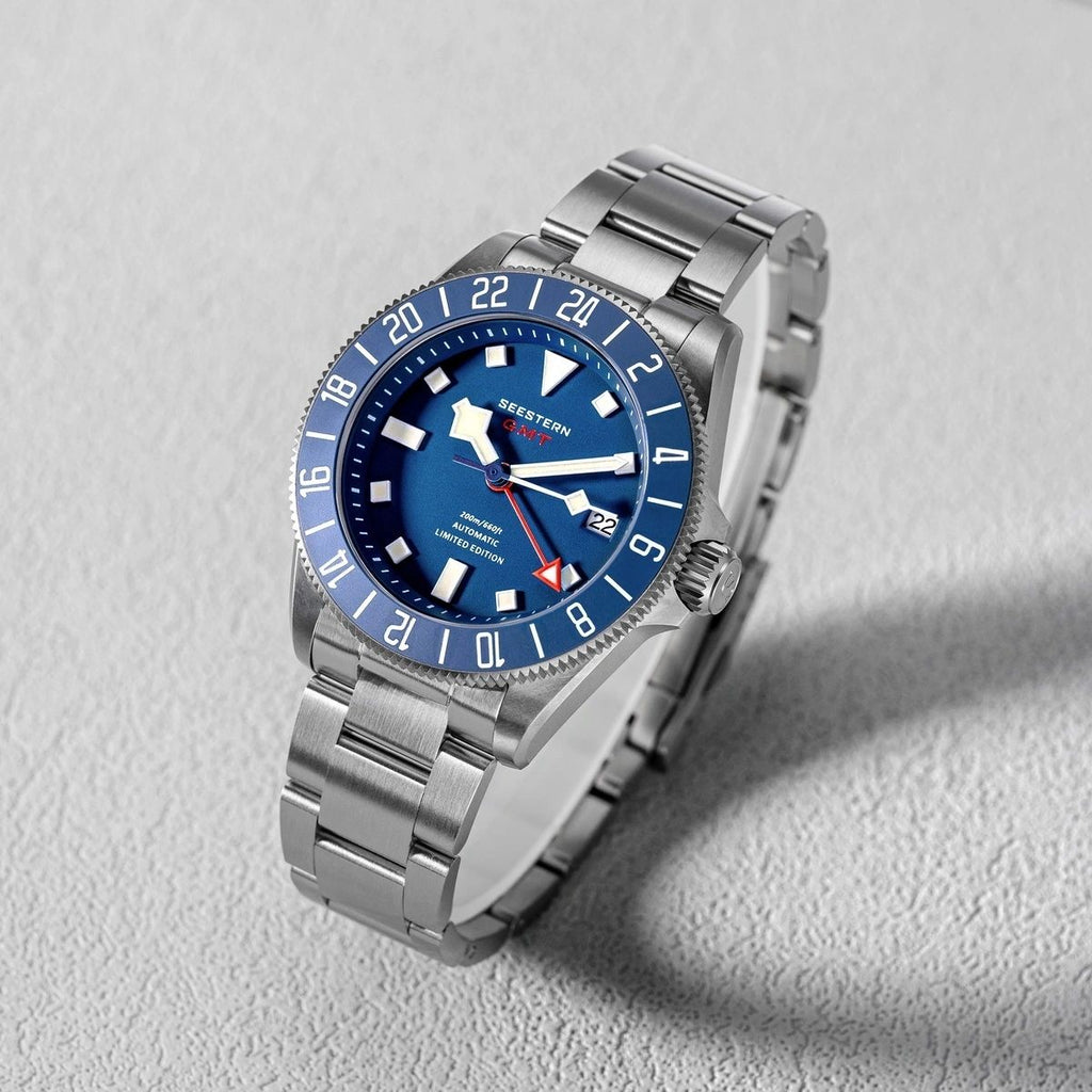 Seestern S462 titanium GMT, blue dial, three-quarter angled view on grey, steel bracelet