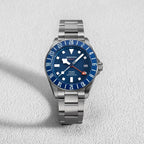 Seestern S462 titanium GMT, blue dial, front flat-lay on white textured surface, steel bracelet
