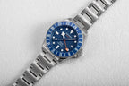 Seestern S462 titanium GMT, blue dial, flat-lay on white textured surface, steel bracelet
