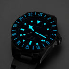 Seestern S462 titanium GMT blue dial and bezel glowing blue lume in the dark, angled close-up