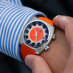 Seestern S471 orange-dial double crown diver worn on wrist with orange rubber strap, close-up