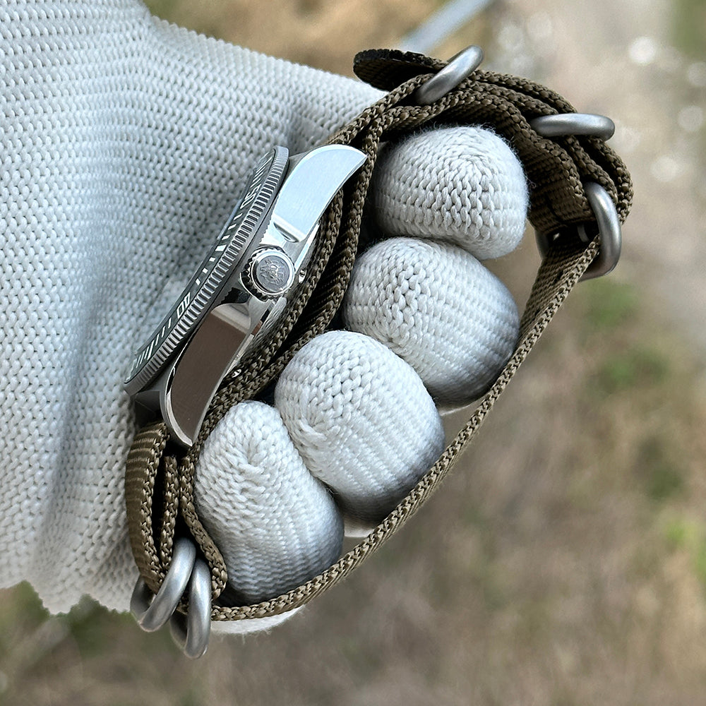 Side profile of the STEELDIVE SD1925 showing the crown and nylon strap through the fixed lug bars
