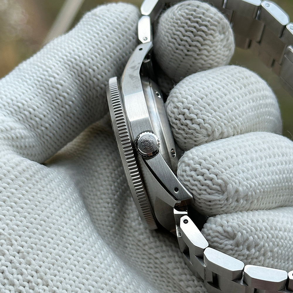 Side profile of the STEELDIVE SD1929V showing the crown and coin-edge bezel on a steel bracelet