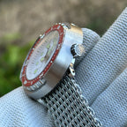 Side profile of the STEELDIVE SD1975N red bezel version showing the signed crown and steel shroud