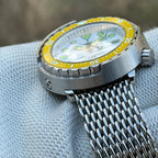 Side view of the STEELDIVE SD1975N yellow bezel version showing the steel shroud and crown