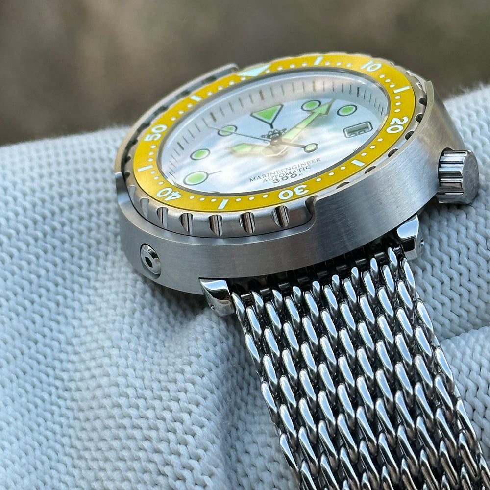 Side view of the STEELDIVE SD1975N yellow bezel version showing the steel shroud and crown