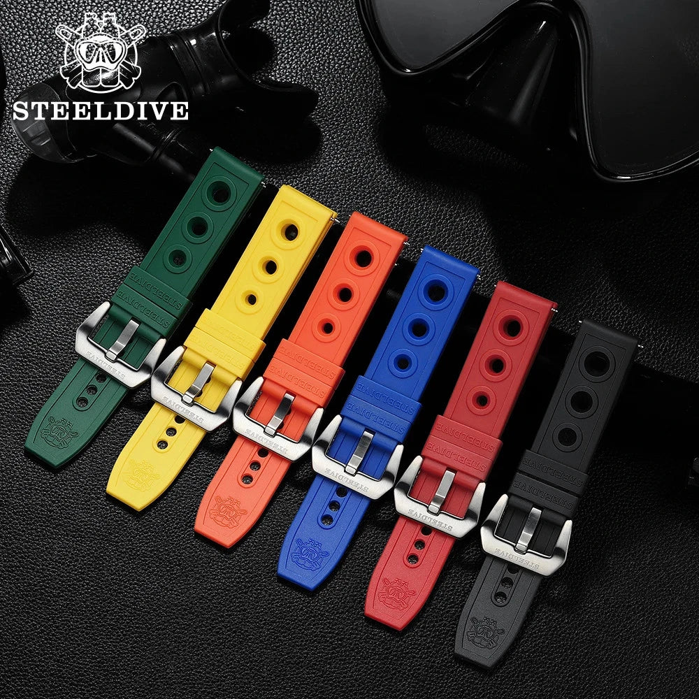 Set of six Steeldive perforated silicone dive straps in green, yellow, orange, blue, red, and black with silver buckles, lined up in a row on a dark background.