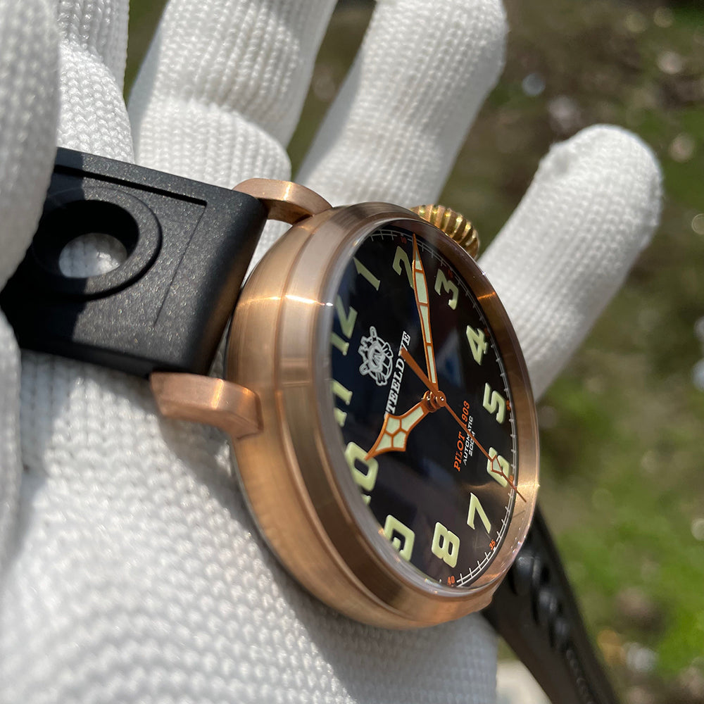 Steeldive SD1903S bronze pilot watch side angle view showing domed crystal, fluted crown and black dial