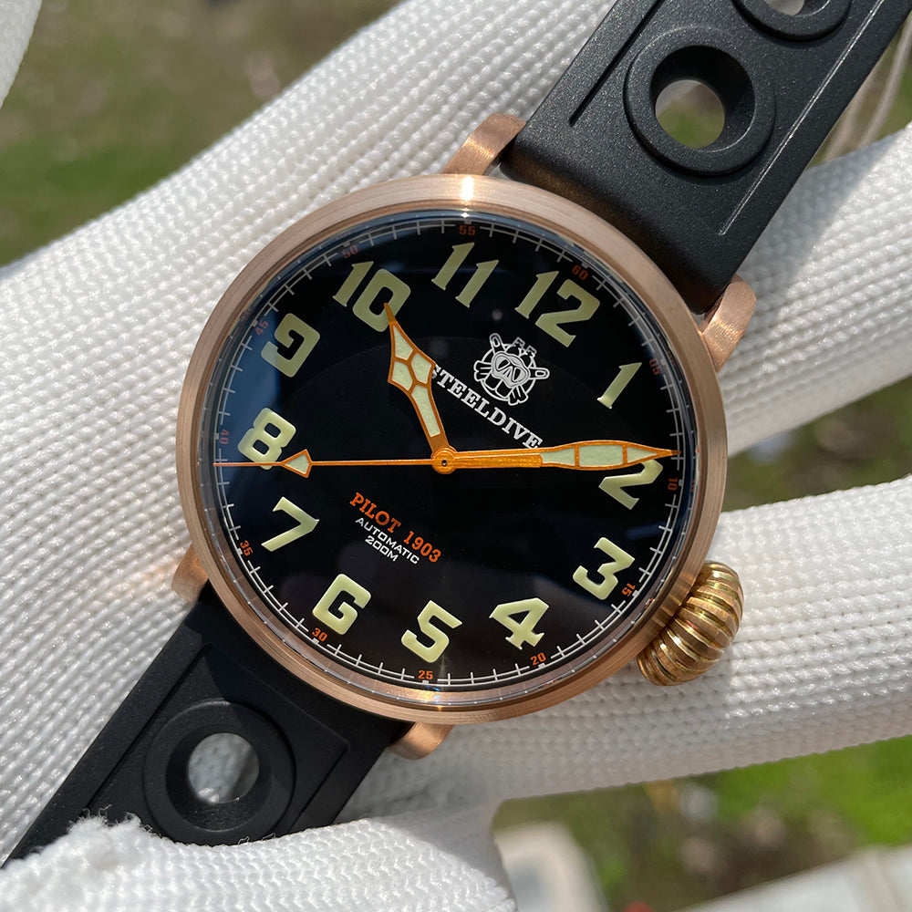 Steeldive SD1903S bronze pilot watch tilted view with rotated dial, C3 green numerals and orange hands