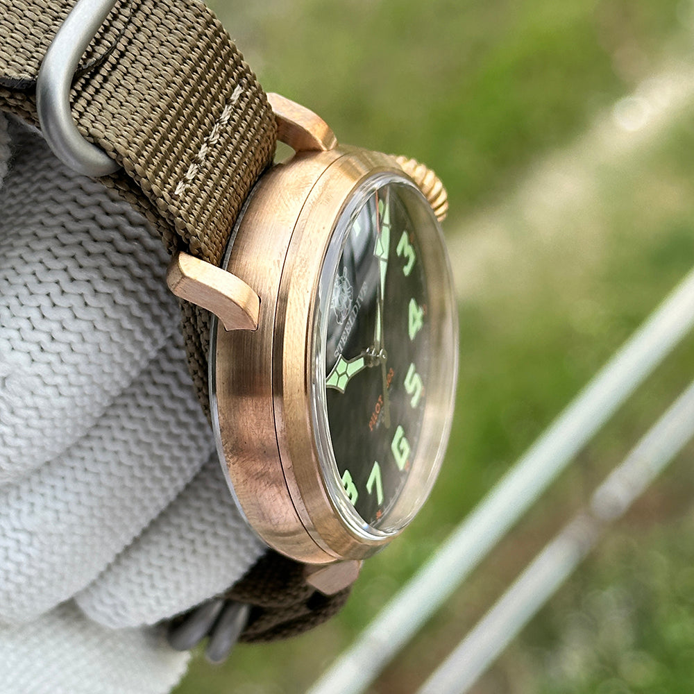 Steeldive SD1903S pilot watch brushed bronze case profile with domed crystal, side view on olive NATO