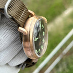 Steeldive SD1903S pilot watch brushed bronze case profile with domed crystal, side view on olive NATO