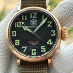 Steeldive SD1903S bronze pilot watch dial close-up with green numerals, minute track and date window at 6