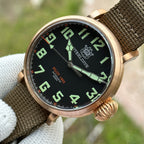 Steeldive SD1903S bronze pilot watch dial macro with C3 green Arabic numerals and orange Pilot 1903 200M text