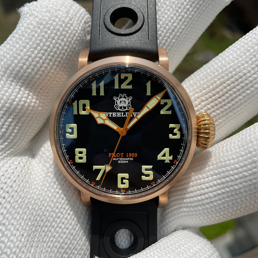 Steeldive SD1903S bronze pilot watch dial macro showing C3 green Arabic numerals and cathedral orange hands