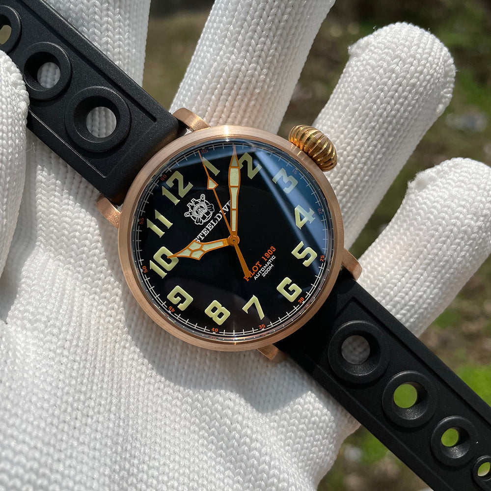 Steeldive SD1903S bronze pilot watch front angle view in gloved hand with black dial and rubber strap