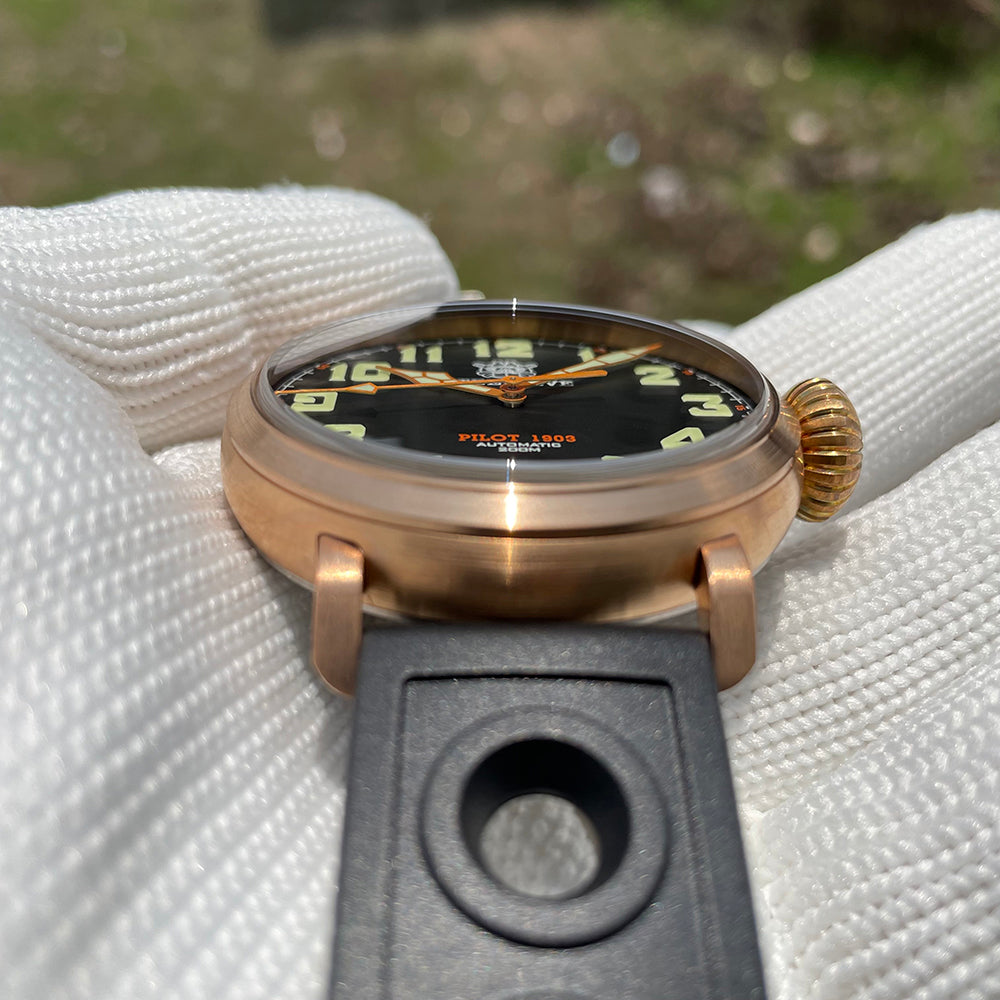 Steeldive SD1903S bronze pilot watch low angle view with black dial, onion crown and perforated rubber strap