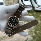 Steeldive SD1903S bronze pilot watch displayed with full olive green NATO strap unbuckled, strap detail