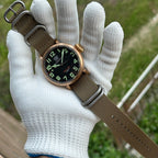Steeldive SD1903S bronze pilot watch resting on white-gloved hand outdoors, lifestyle wrist view