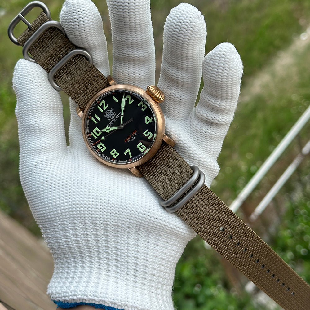 Steeldive SD1903S bronze pilot watch resting on white-gloved hand outdoors, lifestyle wrist view