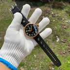 Steeldive SD1903S bronze pilot watch held in gloved hand showing 46.5mm case scale and rubber strap length