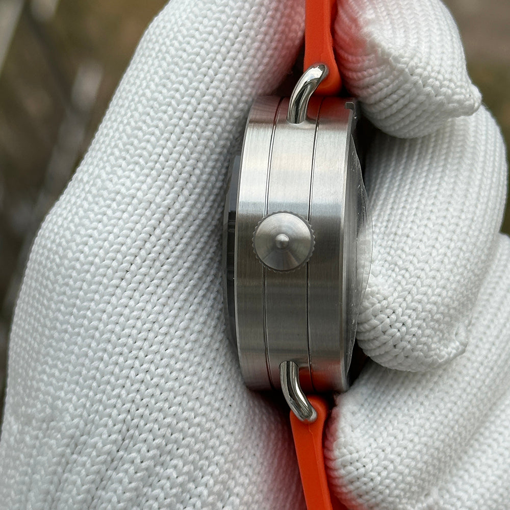 Steeldive SD1912 side profile showing brushed 47mm case flank, screw-down crown and orange rubber strap