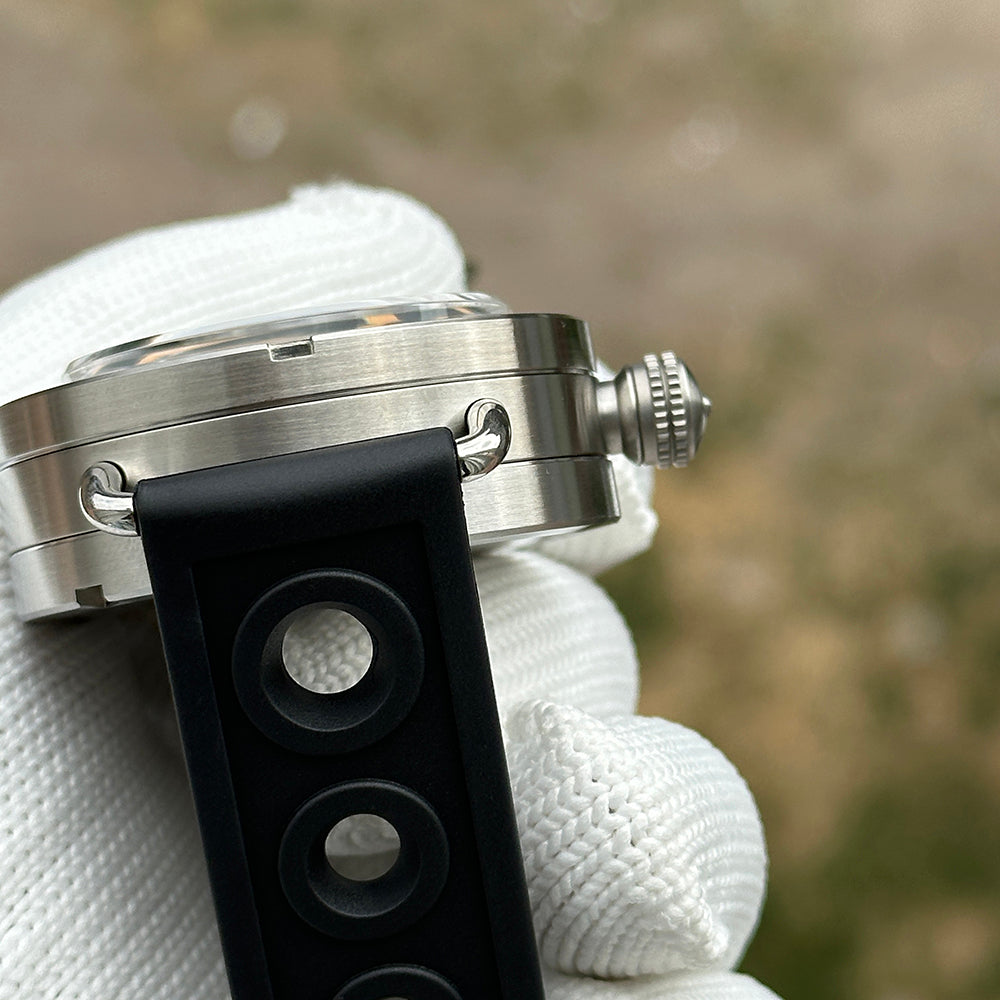 Steeldive SD1912 case flank detail, brushed 47mm midcase, fixed lug bar and black rubber strap close-up