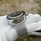 Steeldive SD1912 polished dive watch black dial with shark mesh bracelet, three-quarter angle view