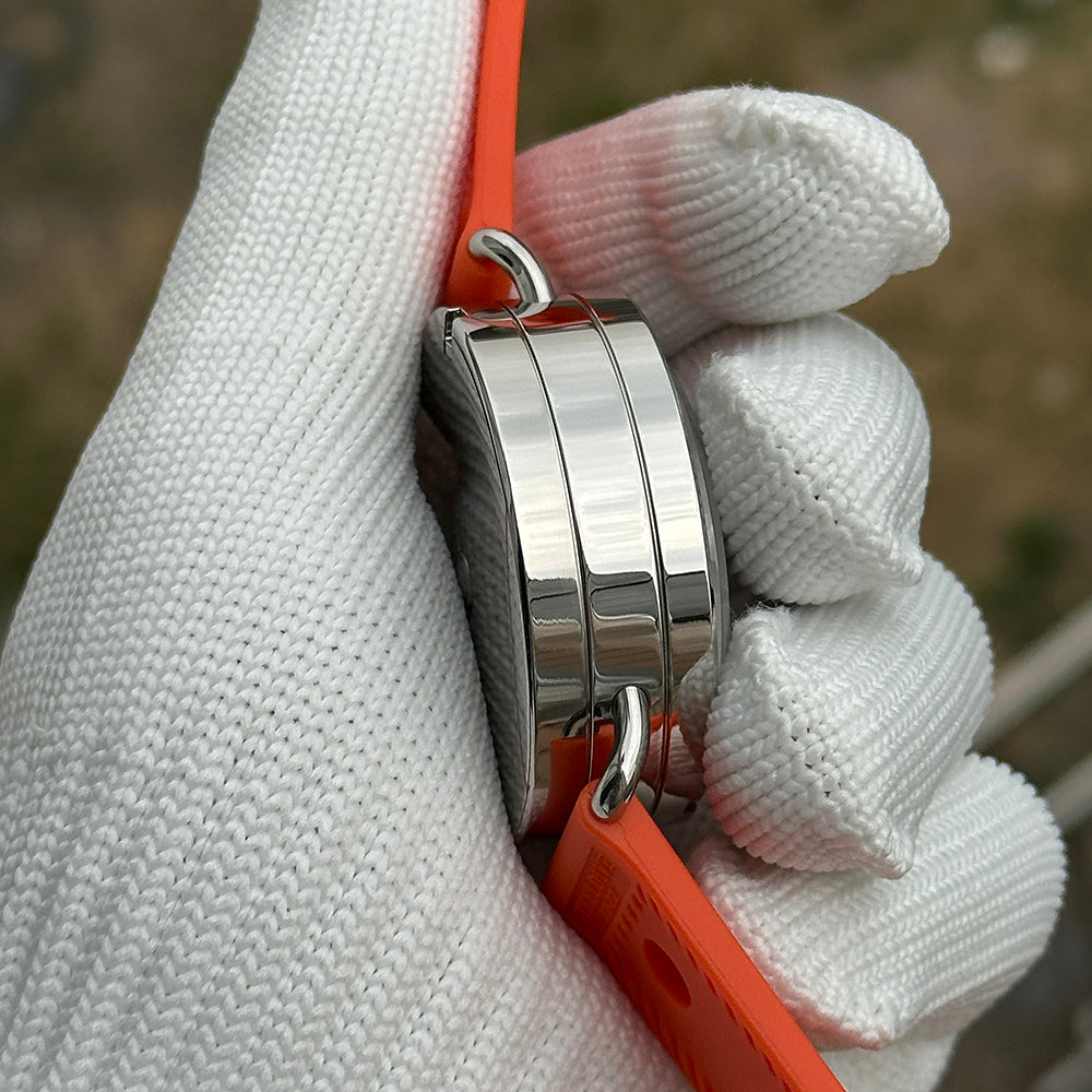 Steeldive SD1912 polished case side view with orange rubber dive strap, three-band case finish