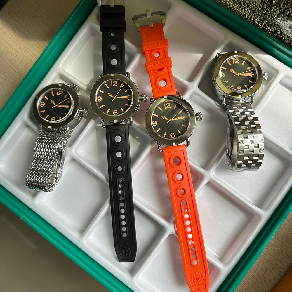 Steeldive SD1912 packaging with three strap options including black rubber, orange rubber and steel bracelets
