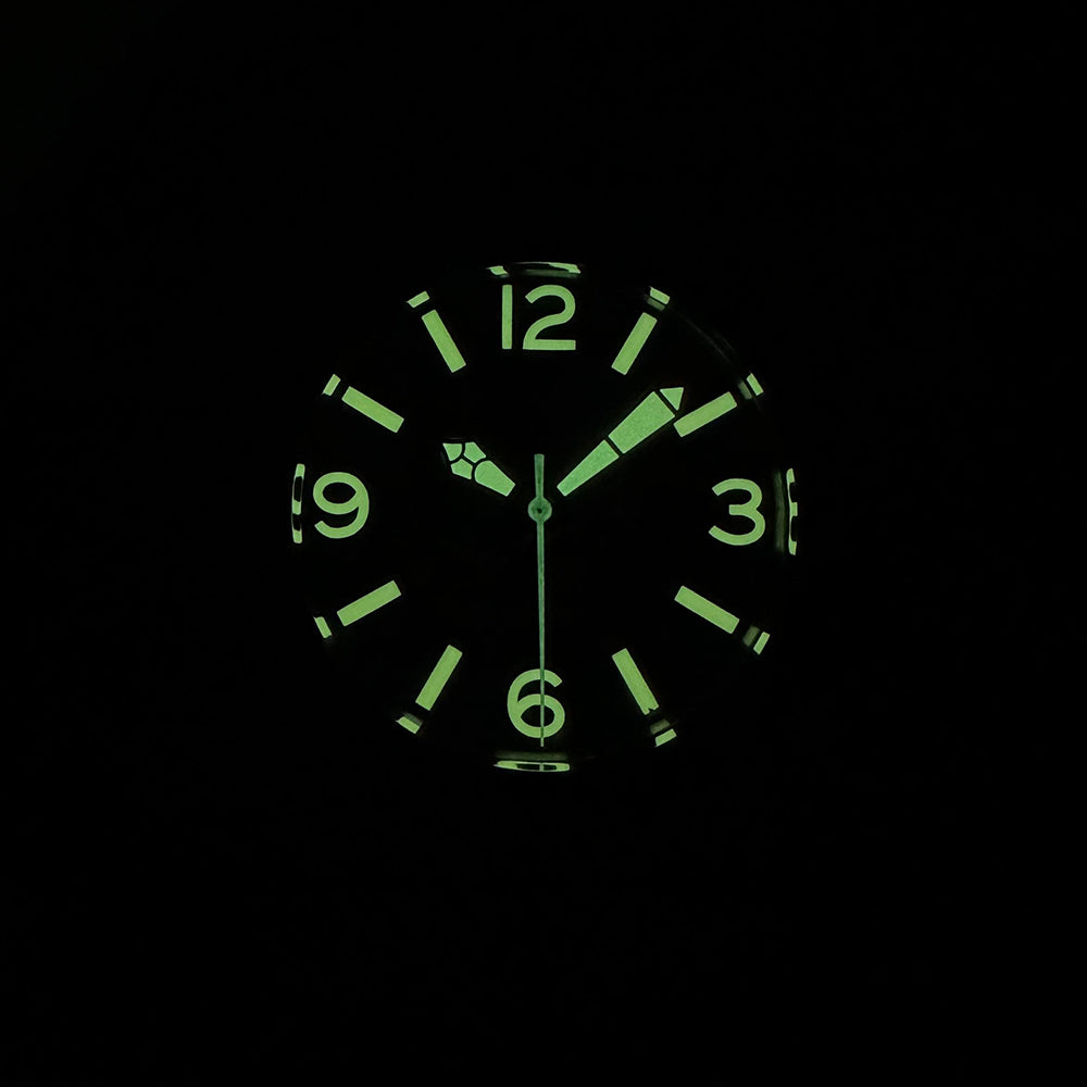 Steeldive SD1912 dive watch lume shot showing bright green C3 lume on Arabic numerals and hands in the dark