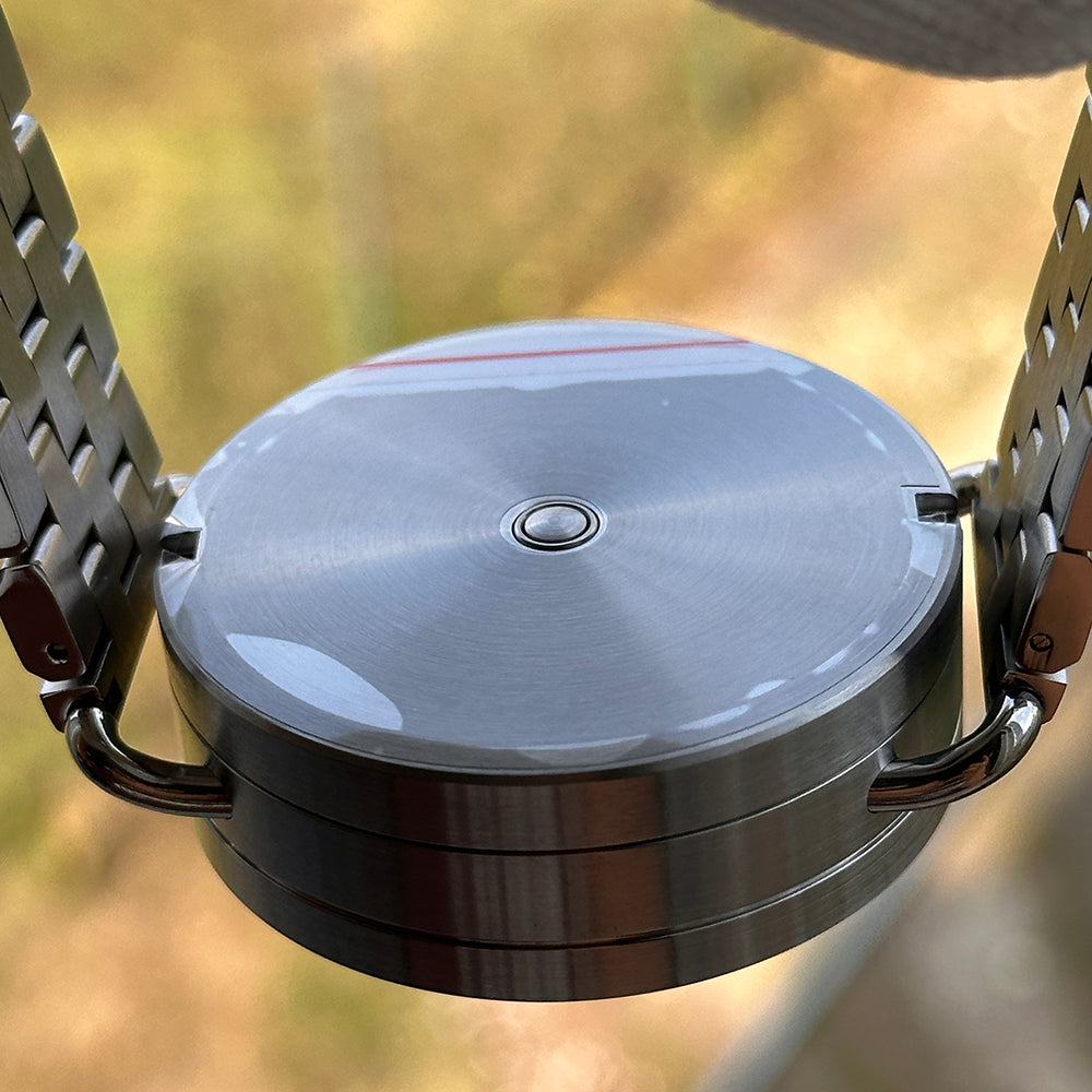 Steeldive SD1912 V2 brushed 3000M dive watch caseback view between bracelet lugs outdoors