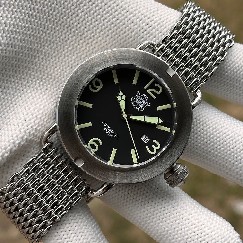 Steeldive SD1912 V2 brushed 3000M dive watch on steel shark mesh bracelet resting on white cloth