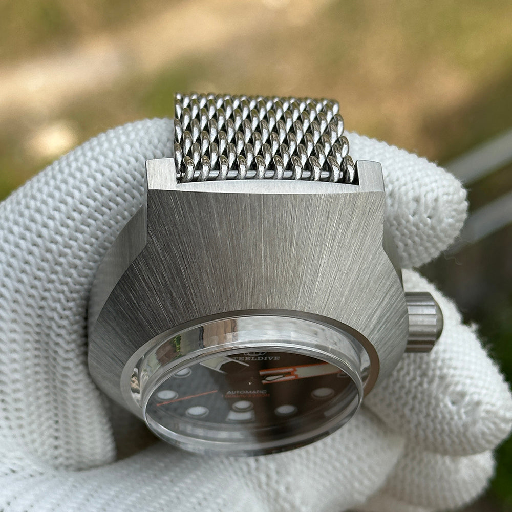 Steeldive SD1920 1000m dive watch crown and case slab detail with mesh bracelet end-link