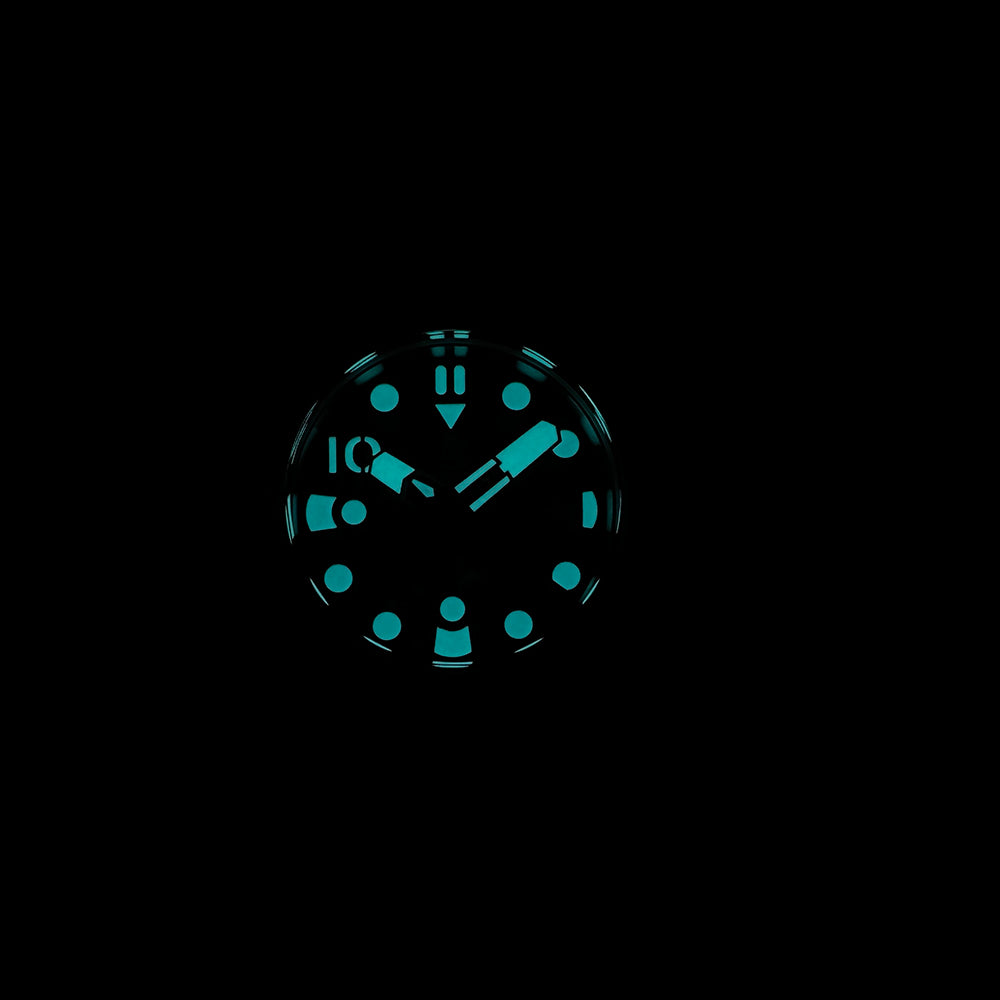 Steeldive SD1920 1000m diver lume shot showing bright blue-green glow on numerals, hands and indices