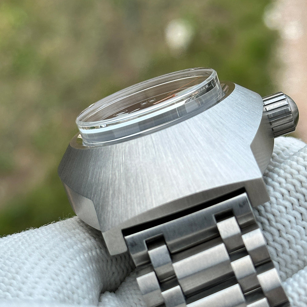 Steeldive SD1920 brushed steel case and tall domed sapphire crystal close-up over tank bracelet