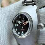 Steeldive SD1920 sapphire glass installed on dive watch with black dial and orange accents, macro view