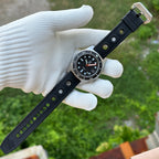 Steeldive SD1929 black dial dive watch on gloved hand with black perforated rubber strap, outdoor shot