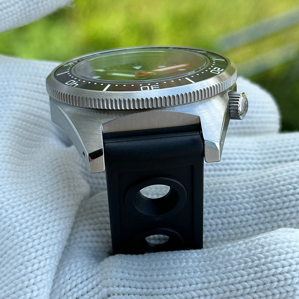 Steeldive SD1929 dive watch outdoor lifestyle shot with sapphire crystal reflecting green foliage tones