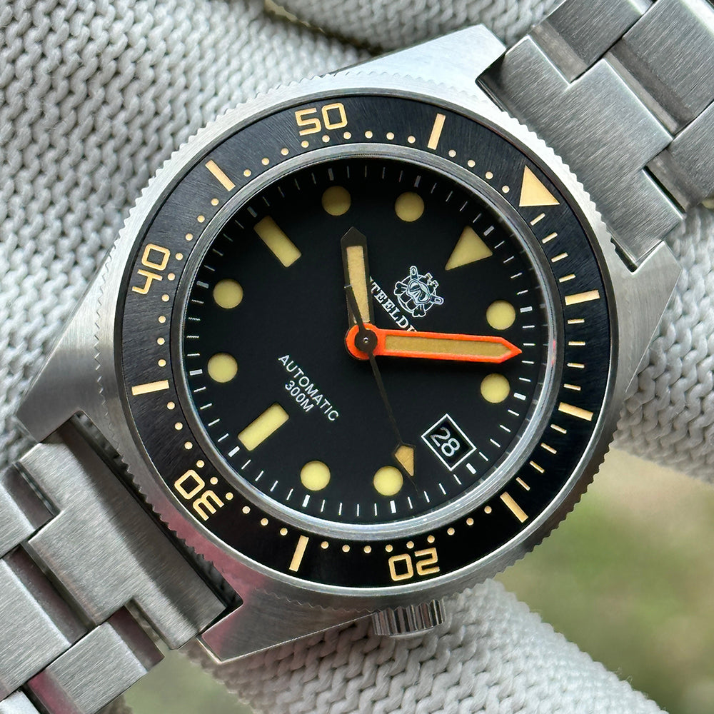 STEELDIVE SD1929V black dial with vintage cream lume and orange minute hand on a steel bracelet