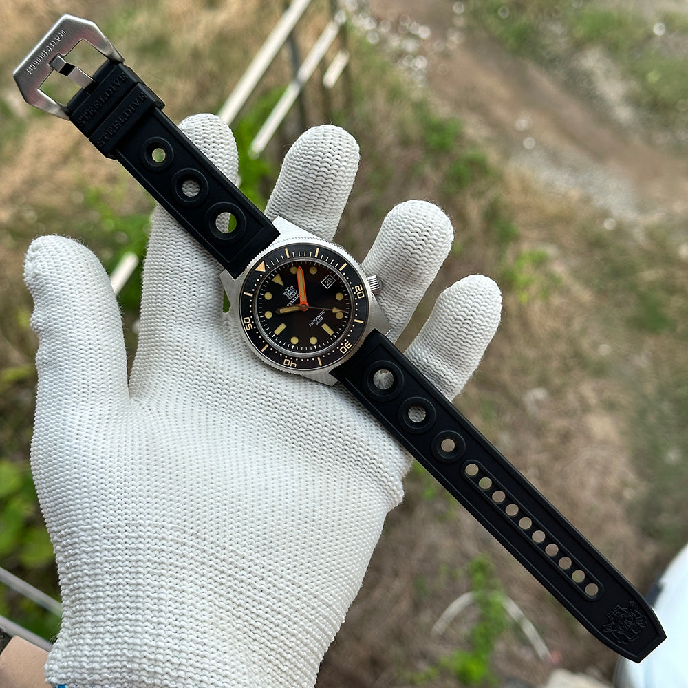 STEELDIVE SD1929V on its black perforated rubber strap held in a gloved hand