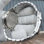Steeldive SD1930 pilot caseback engraved with diver helmet logo and steel bracelet folded around gloved hand