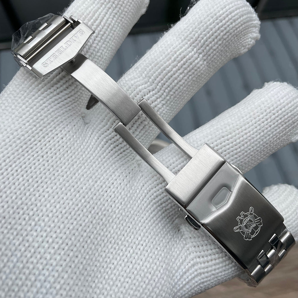 Steeldive SD1930 bracelet folding clasp opened, engraved Steeldive logo and diver helmet emblem, macro detail