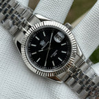 Steeldive SD1933 black dial macro showing applied indices, date window and fluted bezel