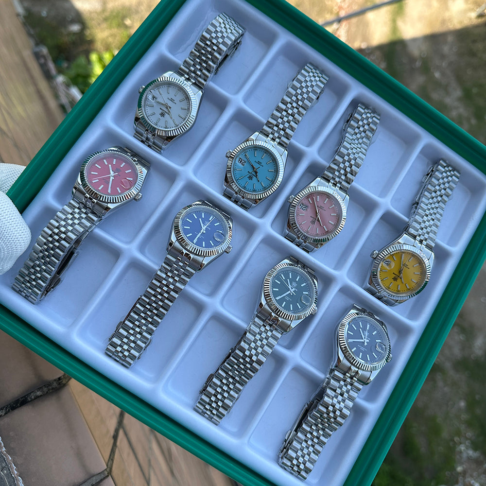 Steeldive SD1933 collection comparison tray showing eight dial colour variants on jubilee bracelets