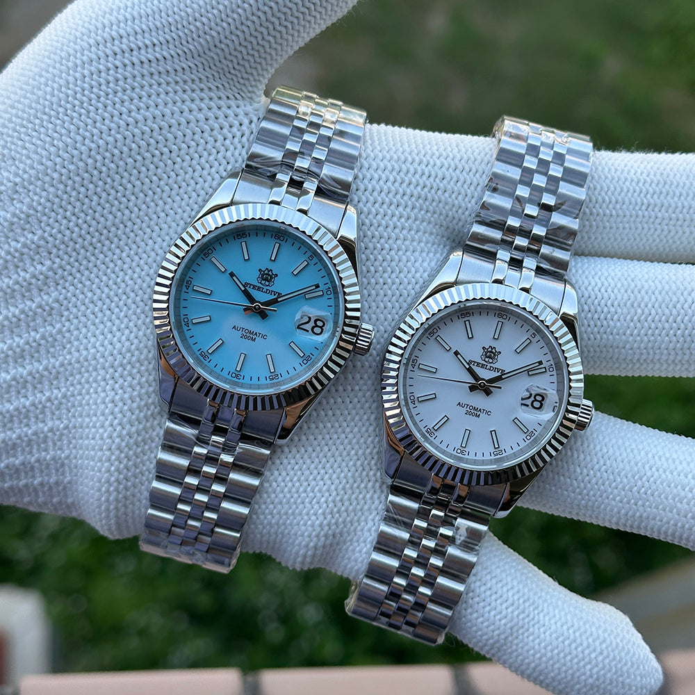 Steeldive SD1933 pair on hand showing sky blue dial beside white dial, jubilee bracelets